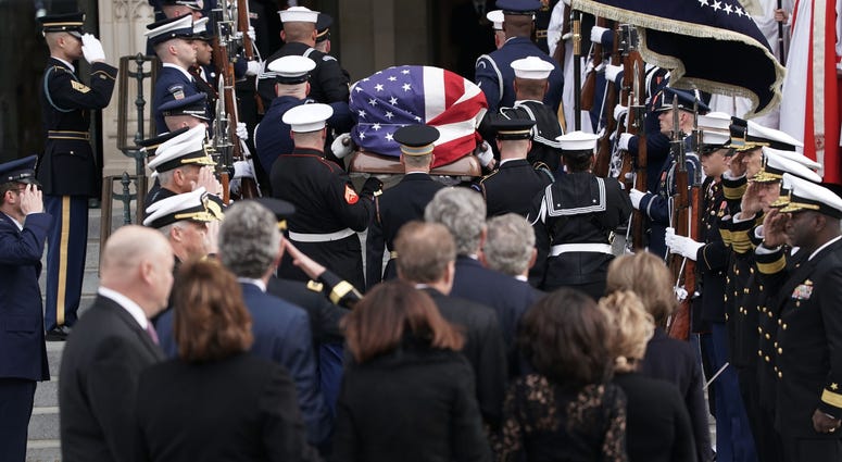 Followed by family members, a joint service honor guard carries the casket of former US President George H.W. Bush into the Washington National Cathedral on December 5, 2018 in Washington, DC. George H.W. Bush