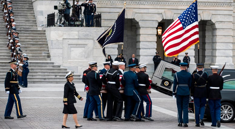 A joint services military honor guard carries the casket of former U.S. President George H. W. Bush from the U.S. Capitol to transport it to Washington National Cathedral for the state funeral on December 5, 2018 in Washington, DC. George H.W. Bush
