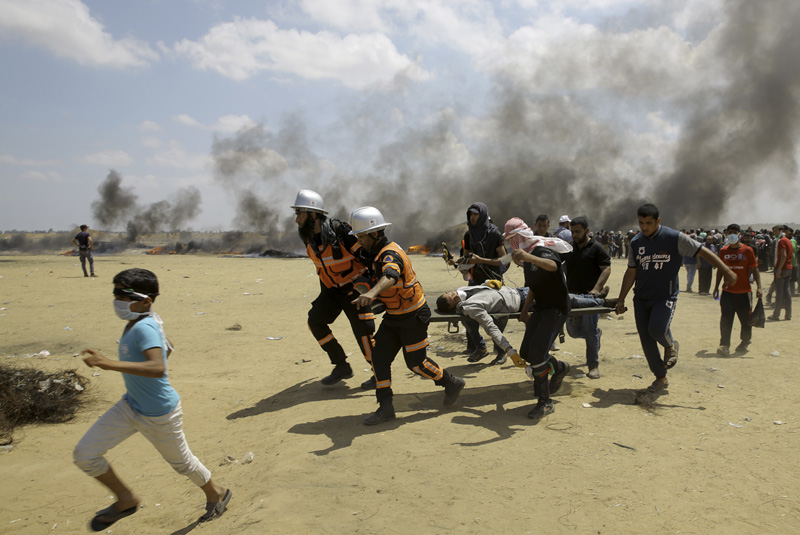 Palestinian medics and protesters evacuate a wounded youth during a protest at the Gaza Strip's border with Israel Palestinian medics and protesters evacuate a wounded youth during a protest at the Gaza Strip's border with Israel