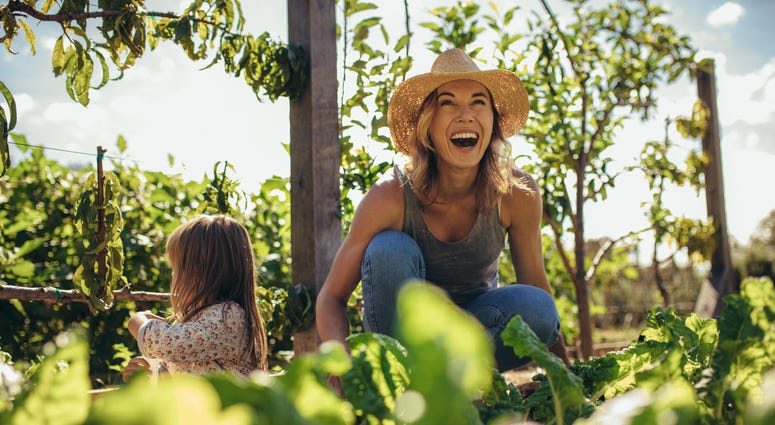 Woman and girl gardening