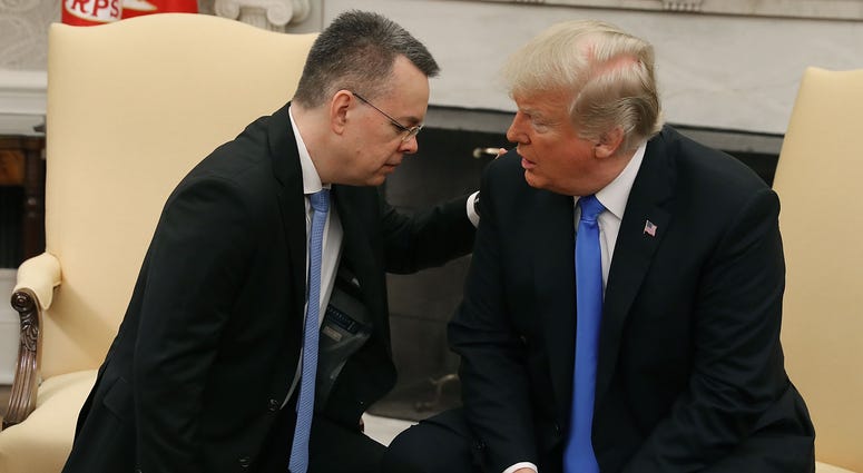 U.S. President Donald Trump and American evangelical Christian preacher Andrew Brunson (L) participate in a prayer in the Oval Office. Trump evangelical