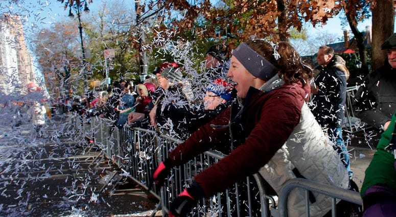 A parade watcher throws confetti during the 92nd annual Macy's Thanksgiving Day Parade on November 22, 2018 in New York City. Thanksgiving Day Parade 2018