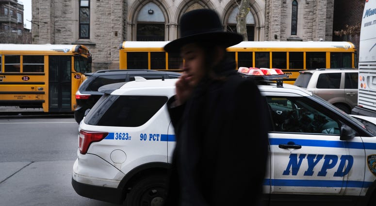 A member of an Orthodox Jewish community walks through a Brooklyn neighborhood on December 29, 2019 in New York City. Hasidic Brooklyn