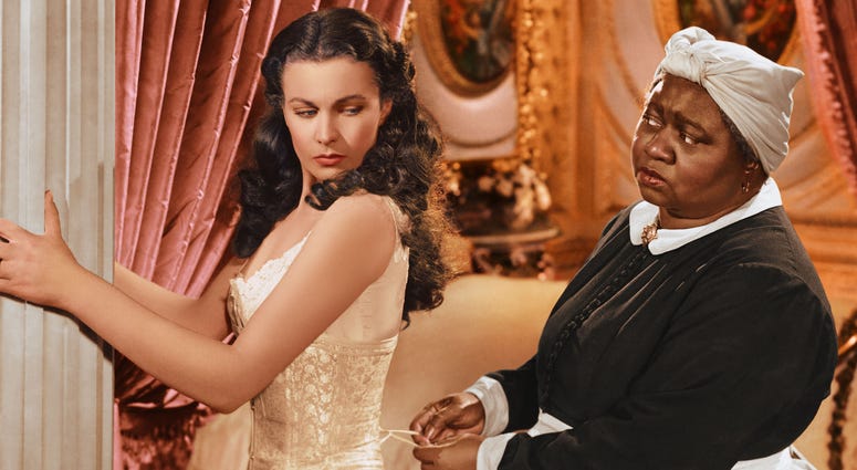 Vivien Leigh (1913-1967), British actress, has her corset tightened by Hattie McDaniel (18921952), US actress, in a publicity still issued for the film, 'Gone with the Wind', 1939. Gone With The Wind