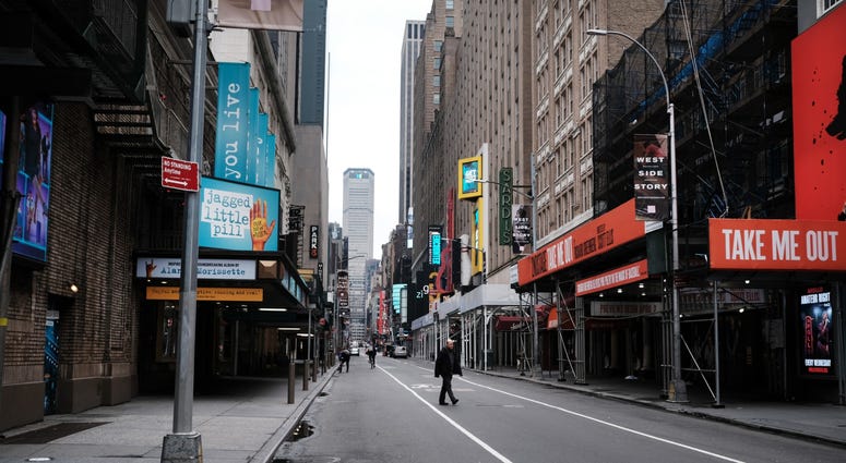 People walk through an empty Times Square on March 19, 2020 in New York City. Coronavirus NYC