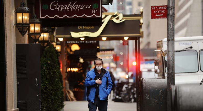eople walk through an empty Times Square on March 19, 2020 in New York City. Coronavirus NYC