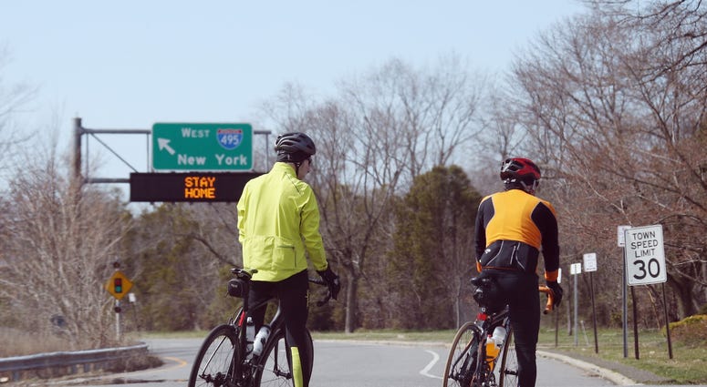 Bicyclists pause for traffic on Broadway on March 21, 2020 in Jericho, New York. Coronavirus NYC