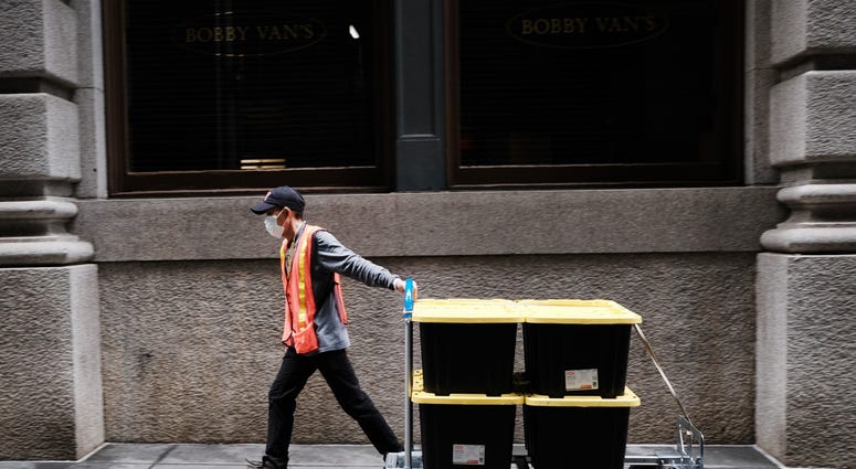A man makes a delivery near the New York Stock Exchange (NYSE) on March 20, 2020 in New York City. Coronavirus NYC