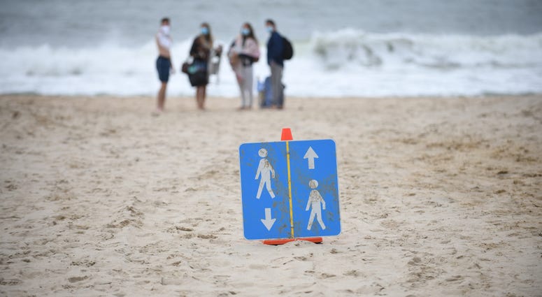 Signs are placed on the beach to direct people on how to keep social distance during Memorial Day weekend on May 24, 2020 in Montauk, New York.