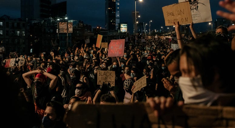 Protesters denouncing police brutality and systemic racism are kept in place on the Manhattan Bridge by police for hours during a citywide curfew in New York City. Manhattan protest day 6