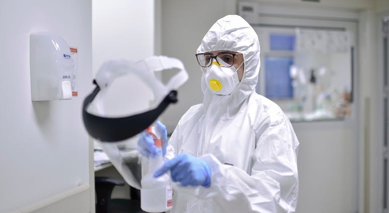 A member of the medical team disinfects a mask at the ICU of Mater Dei hospital amid the coronavirus (COVID-19) pandemic on June 23, 2020 in Belo Horizonte, Brazil. Coronavirus Brazil