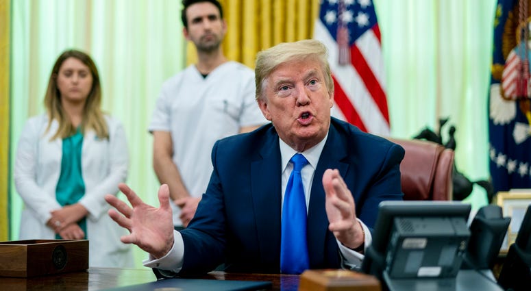 As the novel coronavirus pandemic continues in the United States, President Donald Trump talks to journalists after signing a proclamation honoring National Nurses Day in the Oval Office at the White House May 06, 2020 in Washington, DC. Donald Trump