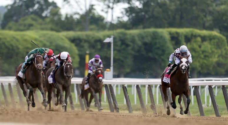 Tiz the Law #8, ridden by jockey Manuel Franco leads the field to the finish line to win the 152nd running of the Belmont Stakes at Belmont Park on June 20, 2020 in Elmont, New York. Tiz the Law