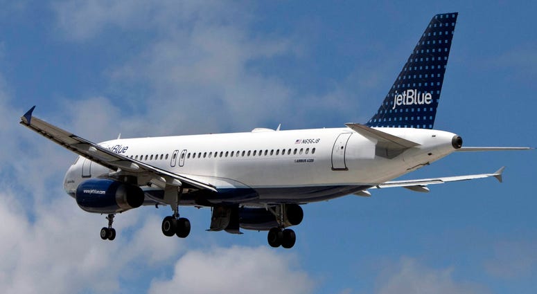 A JetBlue plane flies out of JFK Airport. JetBlue plane