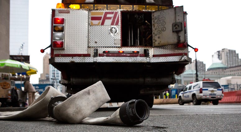 An unused fire hose sits next to fire truck after firemen responded to a two-alarm fire at the World Trade Center on December 26, 2012 in New York City. FDNY fire hose