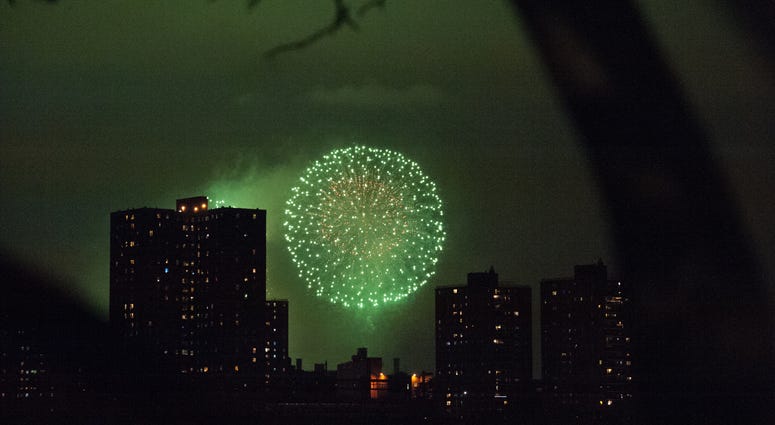 People watch the Macy's Fourth of July Fireworks from Brooklyn Bridge Park on July 4, 2016 in the Brooklyn borough of New York City. NYC fireworks