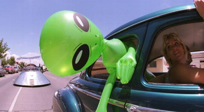 An alien doll hangs out a car window in downtown Roswell, New Mexico Alien doll in Roswell
