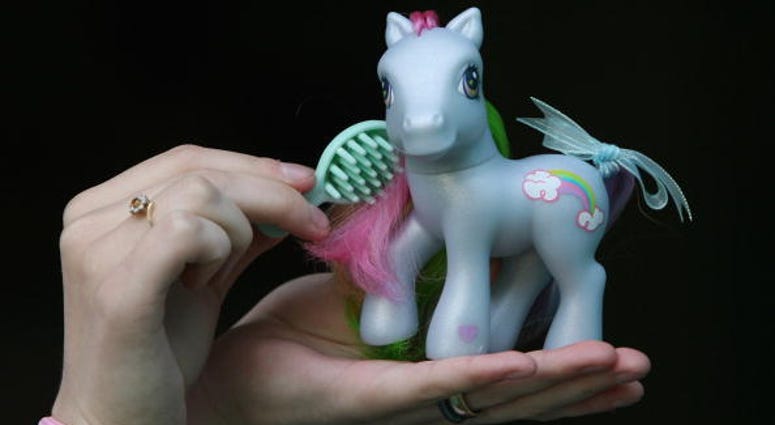 A collector prepares her My Little Pony for display at the My Little Pony Convention A collector prepares her My Little Pony for display at the My Little Pony Convention