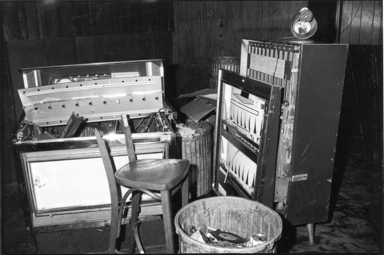 View of a damaged jukebox and cigarette machine, along with a broken chair, inside the Stonewall Inn (53 Christopher Street) after riots over the weekend of June 27, 1969. (Photo by Fred W. McDarrah/Getty Images)