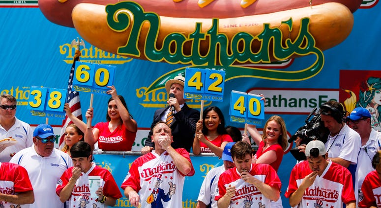Joey Chestnut (2nd L) competes in the annual Nathan's Hot Dog Eating Contest on July 4, 2018 in the Coney Island neighborhood of the Brooklyn borough of New York City. Nathan's Hot Dog Eating Contest