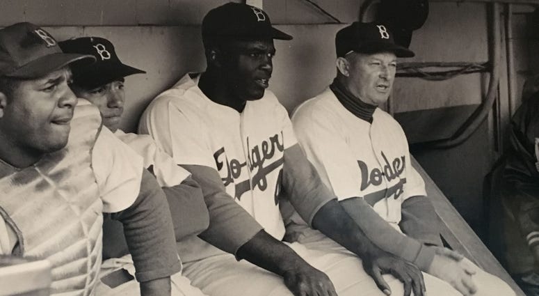 Jackie Robinson in the dugout. Jackie Robinson