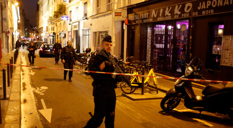 A police officer cordons off the area after a knife attack in central Paris, Saturday May 12, 2018. Paris Knife Attacks