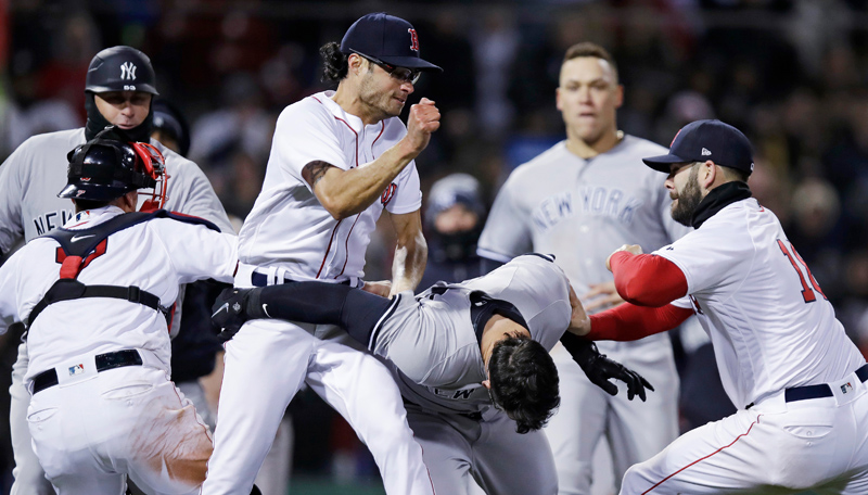 Boston Red Sox relief pitcher Joe Kelly, left, throws a punch at New York Yankees' Tyler Austin, center, as they fight during the seventh inning of a baseball game at Fenway Park in Boston, Wednesday, April 11, 2018. (AP Photo/Charles Krupa) Boston Red Sox relief pitcher Joe Kelly, left, throws a punch at New York Yankees' Tyler Austin, center, as they fight during the seventh inning of a baseball game at Fenway Park in Boston, Wednesday, April 11, 2018. (AP Photo/Charles Krupa)