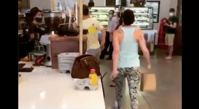 The mask-less woman is seen coughing at a Queens bagel shop. Mask-less woman coughs Queens bagel shop
