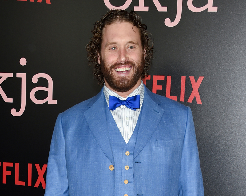 FILE - In this June 8, 2017 file photo, actor T.J. Miller attends the premiere of Netflix's "Okja" in New York. Miller was arrested Monday night, April 9, 2018, at LaGuardia Airport in New York and charged with calling 911 to falsely claim that a woman on FILE - In this June 8, 2017 file photo, actor T.J. Miller attends the premiere of Netflix's "Okja" in New York. Miller was arrested Monday night, April 9, 2018, at LaGuardia Airport in New York and charged with calling 911 to falsely claim that a woman on
