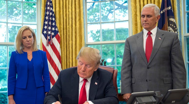 President Donald Trump signs an executive order to keep families together at the border, but says that the 'zero-tolerance' prosecution policy will continue, during an event in the Oval Office of the White House in Washington, Wednesday, June 20, 2018. Trump Order On Migrant Children
