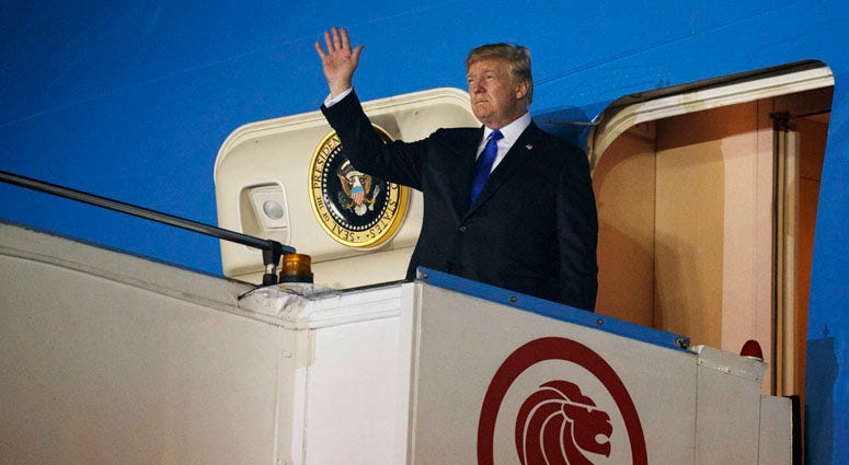 President Donald Trump arrives at Paya Lebar Air Base for a summit with North Korea's leader Kim Jong Un, Sunday, June 10, 2018, in Singapore. President Donald Trump In Singapore
