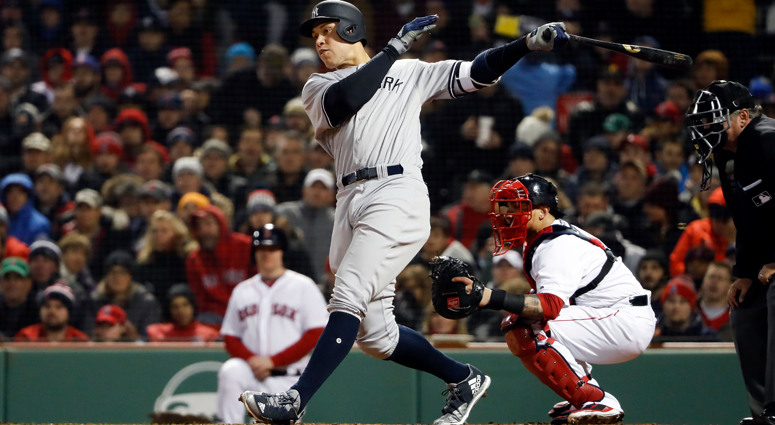 New York Yankees right fielder Aaron Judge (99) hits a single in the fourth inning against the Boston Red Sox at Fenway Park. New York Yankees Aaron Judge