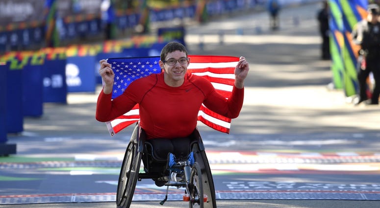 Daniel Romanchuk poses for a photo after winning the men's push rim wheelchair race in the 2018 TCS New York City Marathon. NYC Marathon