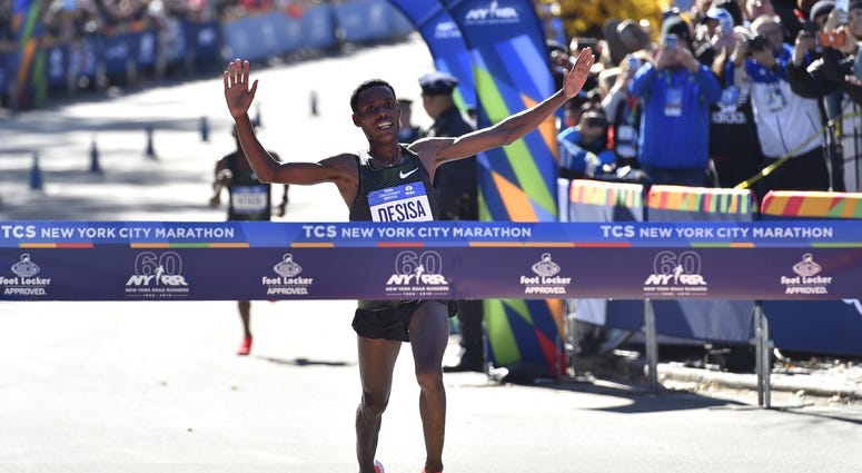 Lelisa Desisa crosses the finish line to win the professional men's division race of the 2018 TCS New York City Marathon. NYC Marathon