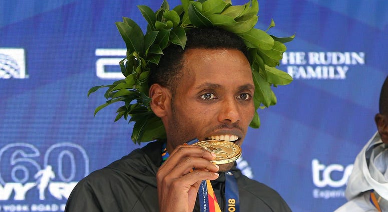 Lelisa Desisa of Ethiopia poses during the medal ceremony after winning the New York City Marathon in New York, NY. NYC Marathon