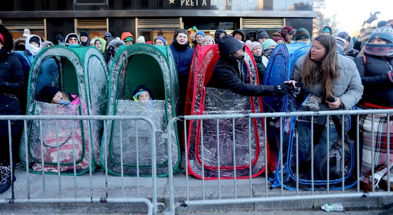 One family found a way to stay warm as they watched the annual Macy's Thanksgiving Day Parade in Manhattan Nov. 22, 2018. Thanksgiving Parade