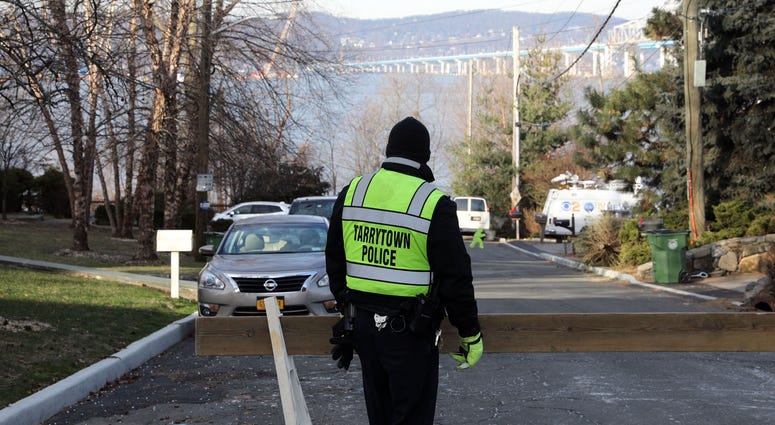 A police officer stands on Van Wart Avenue as people head to the Riverwalk to get a view of the demolition of the eastern portion of the Tappan Zee Bridge Jan. 15, 2019 in Tarrytown. Tappan Zee Demolition