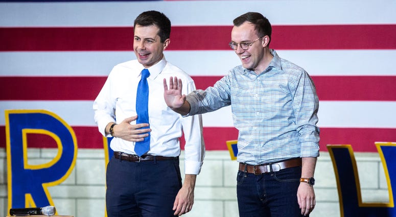 Democratic presidential candidate Pete Buttigieg, former mayor of South Bend, Ind., (left) and his husband Chasten Buttigieg wave after a town hall campaign event. Pete Buttigieg and husband
