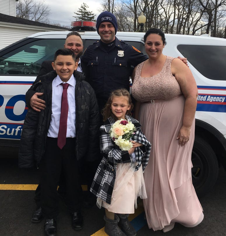 Officer Cody Matthews with Joseph DeMichele, Feliece Terwilliger, 10-year-old Jayden and 5-year-old Gianna. Cop drives couple to wedding