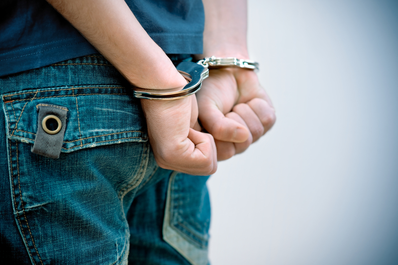 Teenager in handcuffs. Teenager in handcuffs.