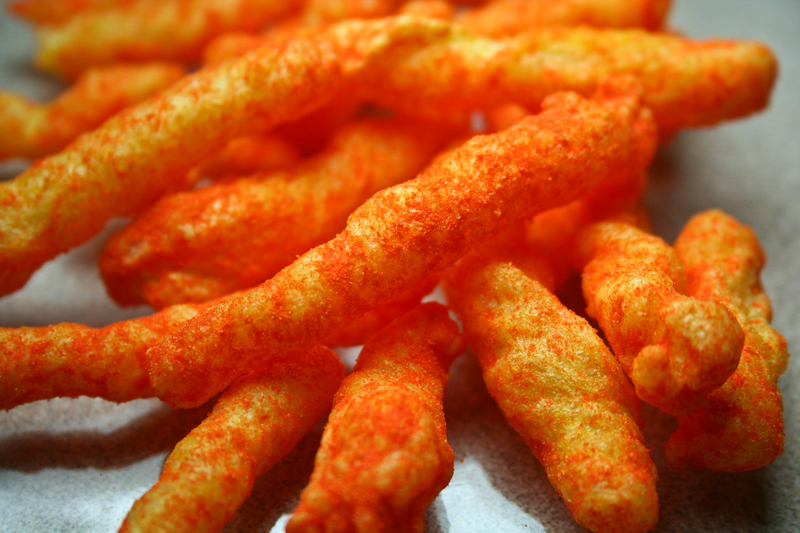 A close up view of a snack size portion of cheesy, crispy cheetos A close up view of a snack size portion of cheesy, crispy cheetos
