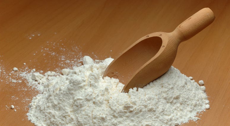 Flour and a wooden spoon. Flour