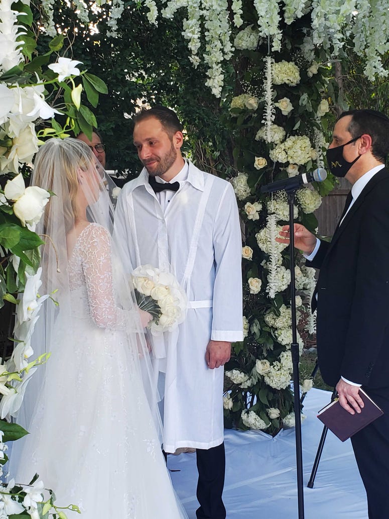 Ashley and Israel are married in the backyard ceremony. Ashley and Israel