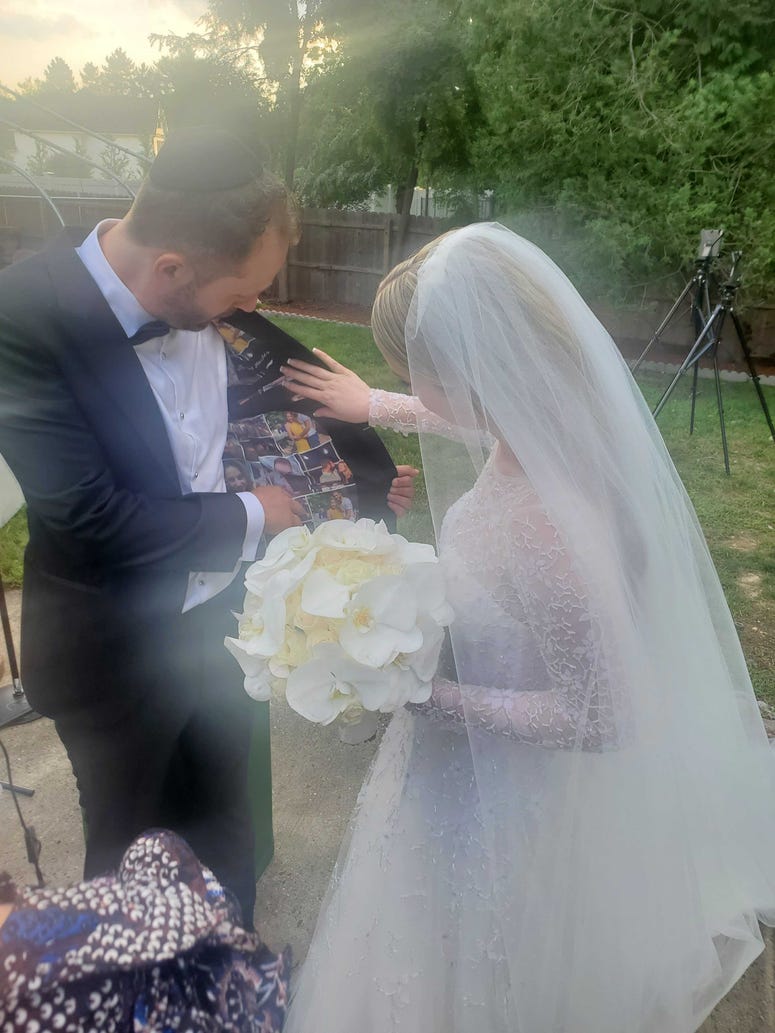 Ashley looks at Israel's tuxedo, which includes photos of the two together. Ashley and Israel
