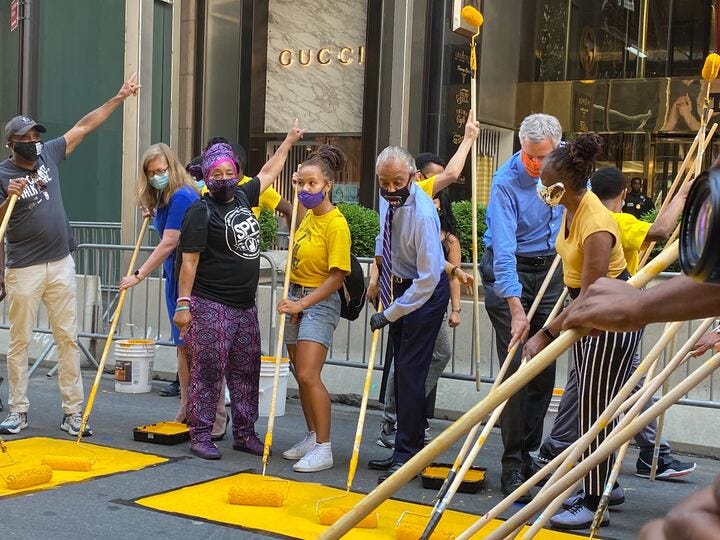 De Blasio takes part in the painting of the mural. De Blasio