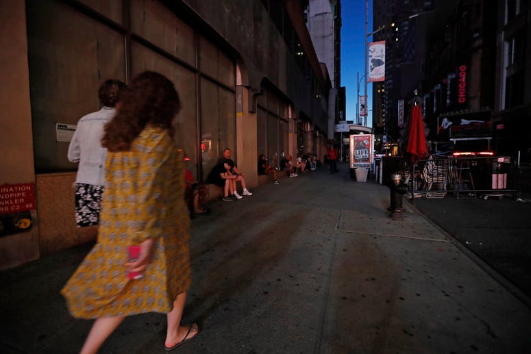 People walk in midtown Manhattan during a widespread power outage, Saturday, July 13, 2019, in New York. NYC blackout