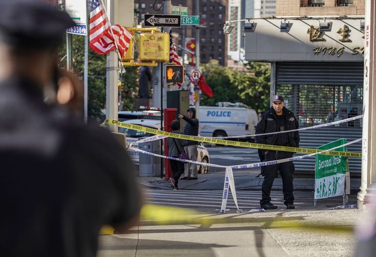 New York Police Department officers investigate the scene of an attack in Manhattan's Chinatown neighborhood, Saturday, Oct. 5, 2019 in New York. Homeless men attacked