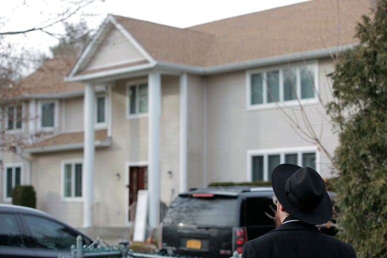 An onlooker stands outside a rabbi's residence in Monsey, N.Y., Sunday, Dec. 29, 2019, following a stabbing Saturday night during a Hanukkah celebration. Monsey stabbing