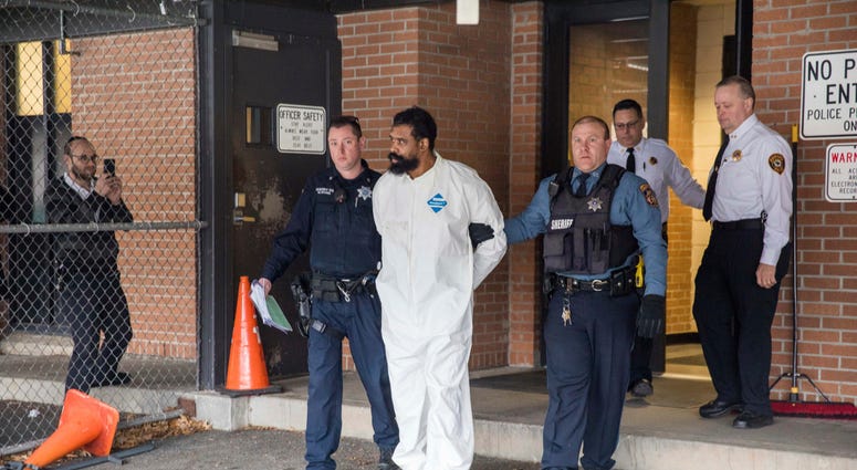 Ramapo police officers escort Grafton Thomas from Ramapo Town Hall to a police vehicle, Sunday, Dec. 29, 2019, in Ramapo, N.Y. Grafton Thomas