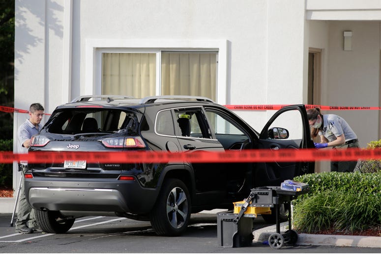 Forensic technicians work on the vehicle authorities say officers fired shots at, that breached security at President Donald Trump's Mar-a-Lago resort in Palm Beach, Friday, Jan. 31, 2020, in West Palm Beach, Fla. Mar-a-Lago